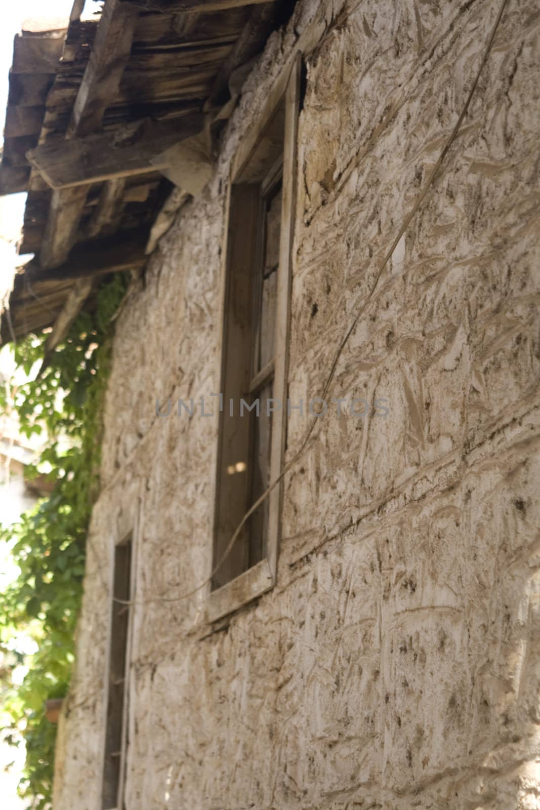 Wall with window of an old house in a village