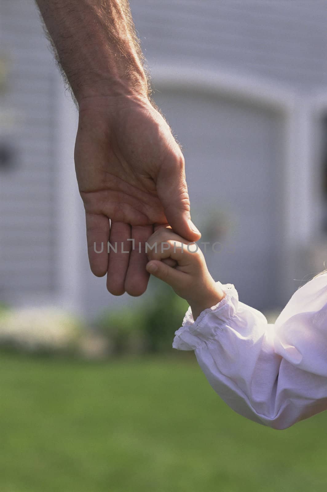 Father Daintily Holding Tiny Hand of Daughter