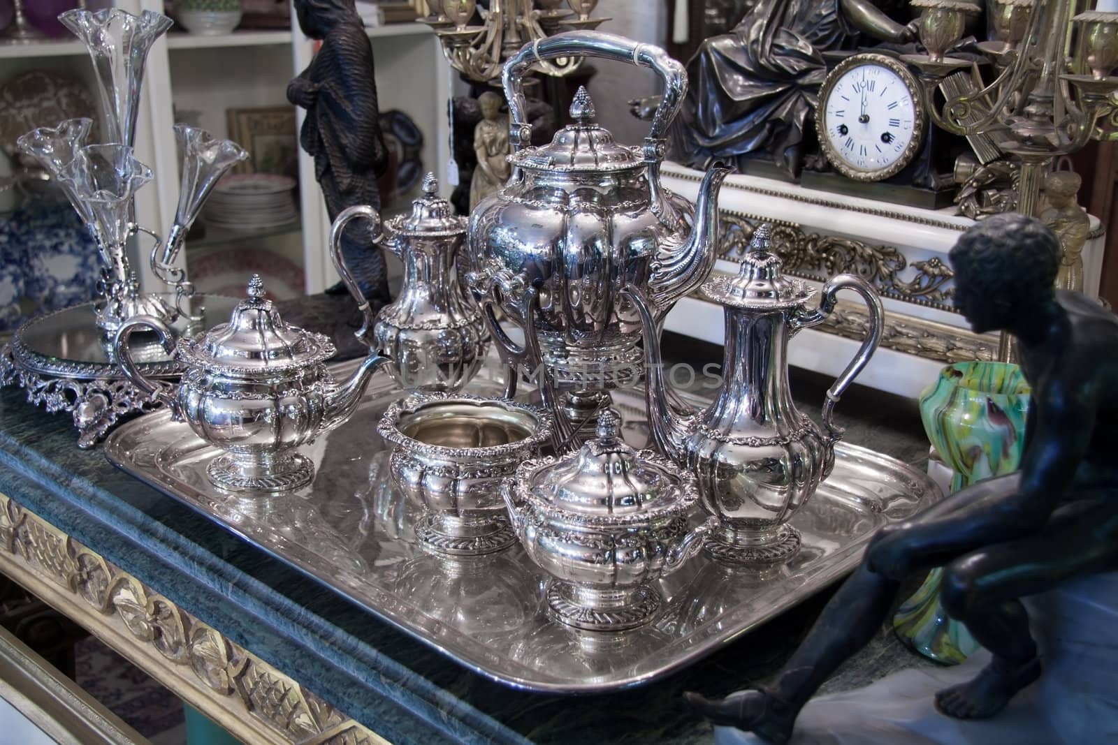 Vintage sterling silver Coffee Tea set displayed in antique store