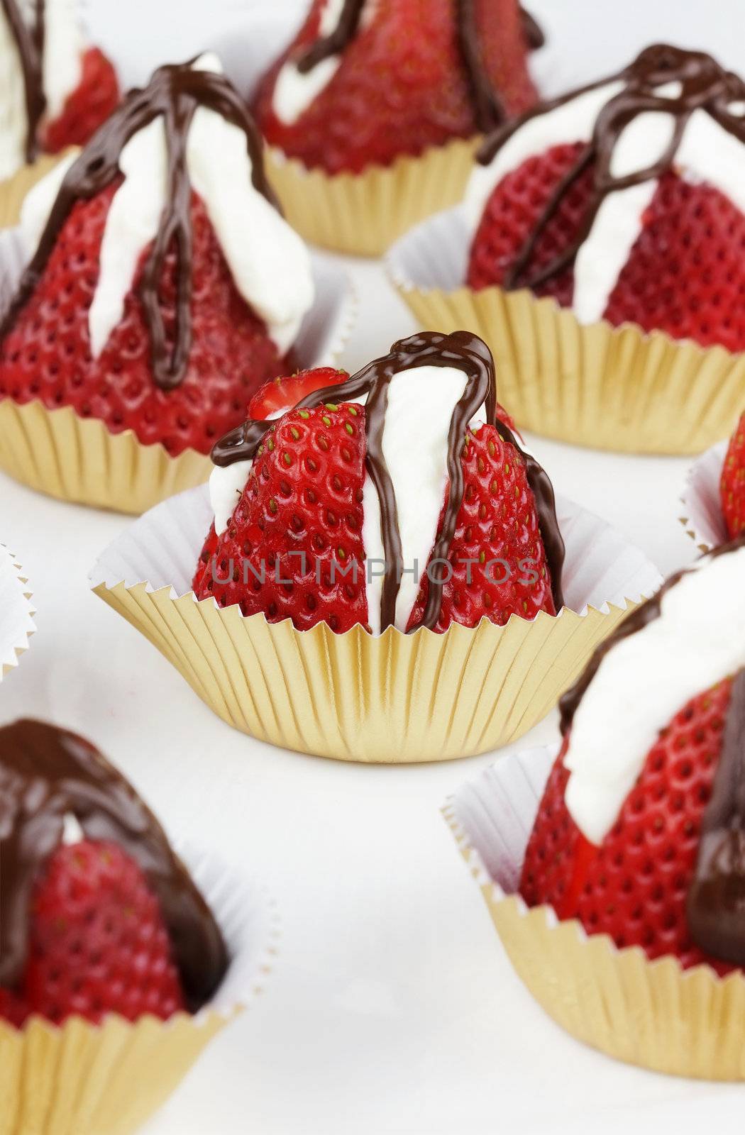 Strawberries filled with white chocolate and then drizzled
