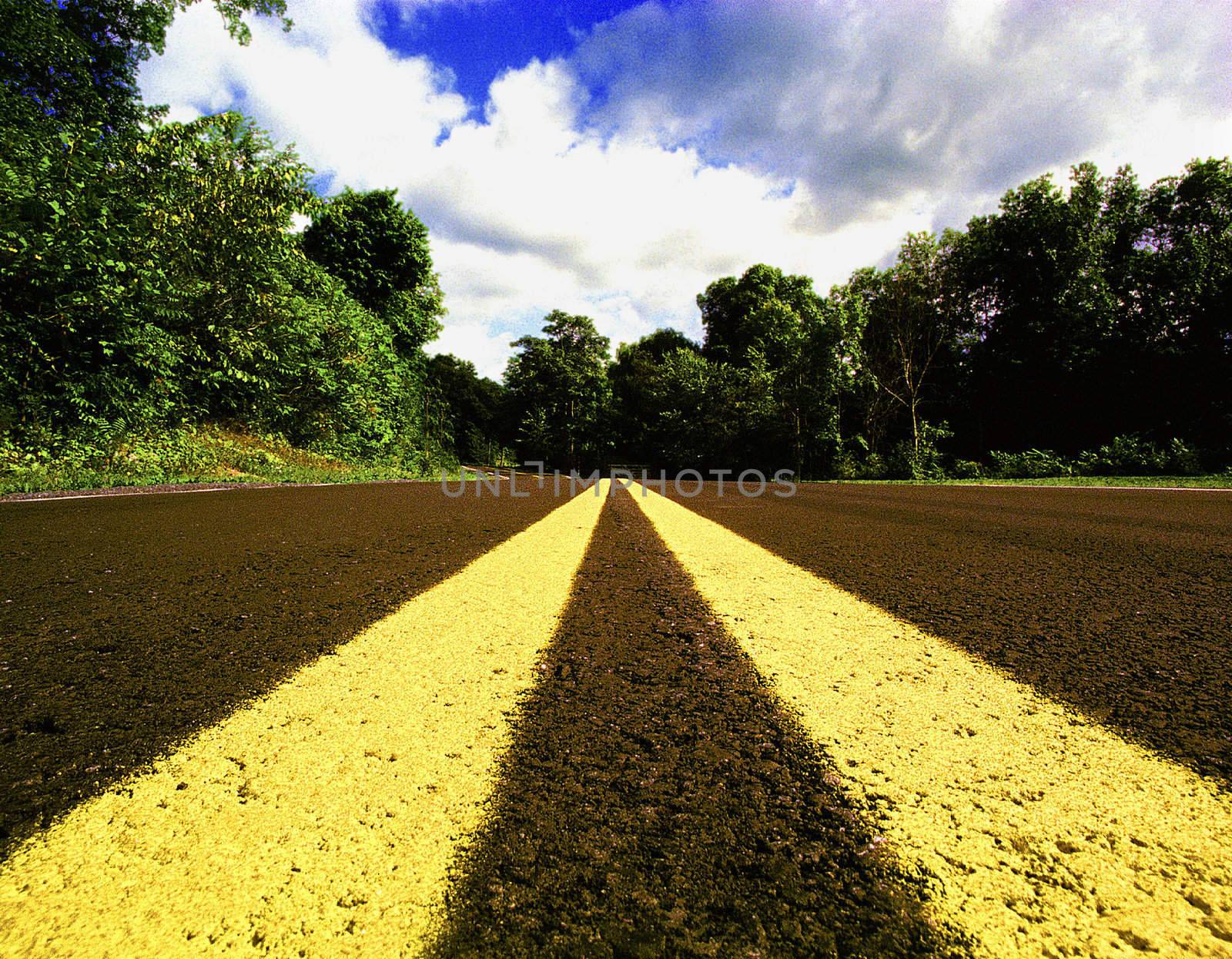 Close Up of Double Yellow Line through Scenic Landscape by photo_guru