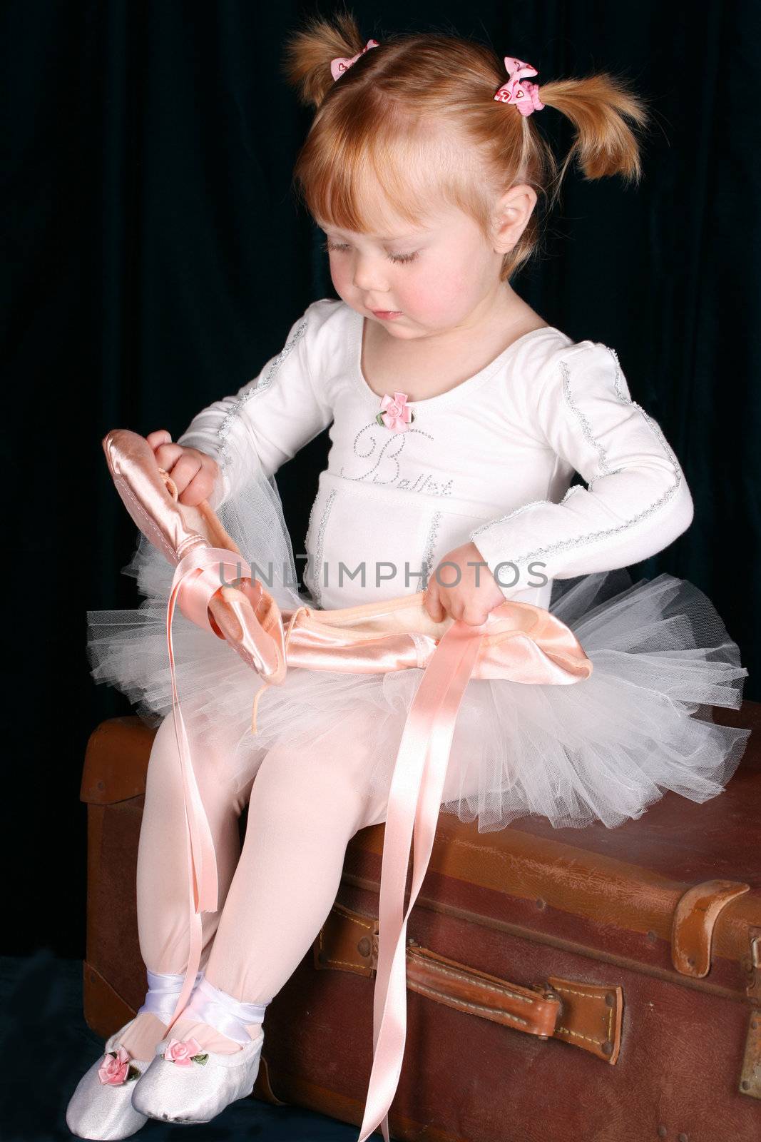 Little ballet toddler wearing a white tutu
