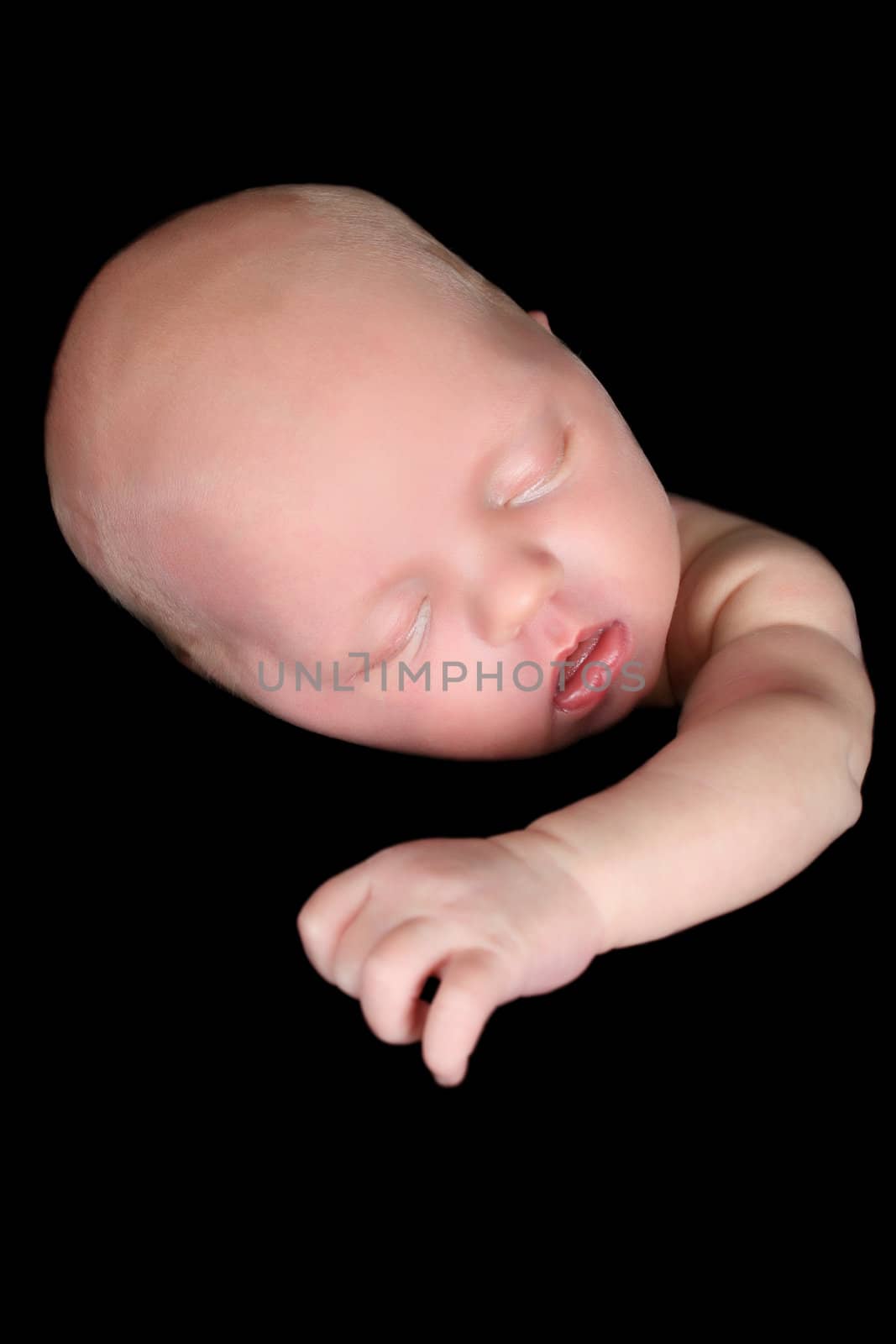 Beautiful newborn baby girl sleeping on a black background