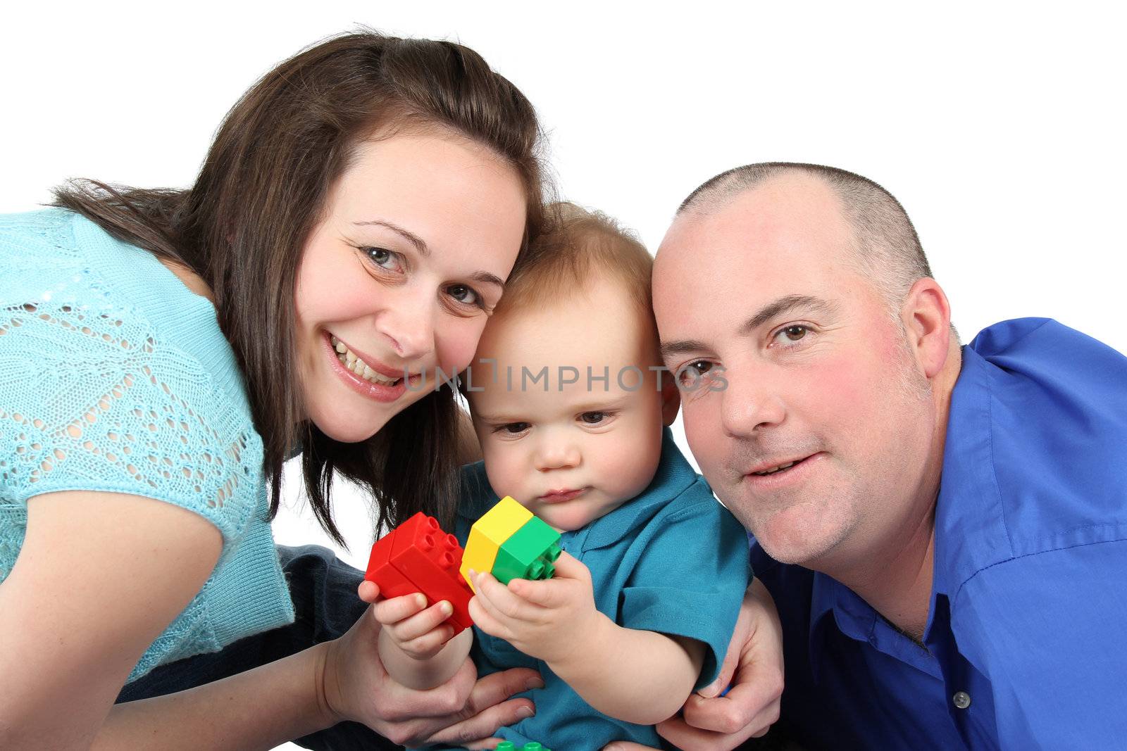 Family playing with building blocks against white background
