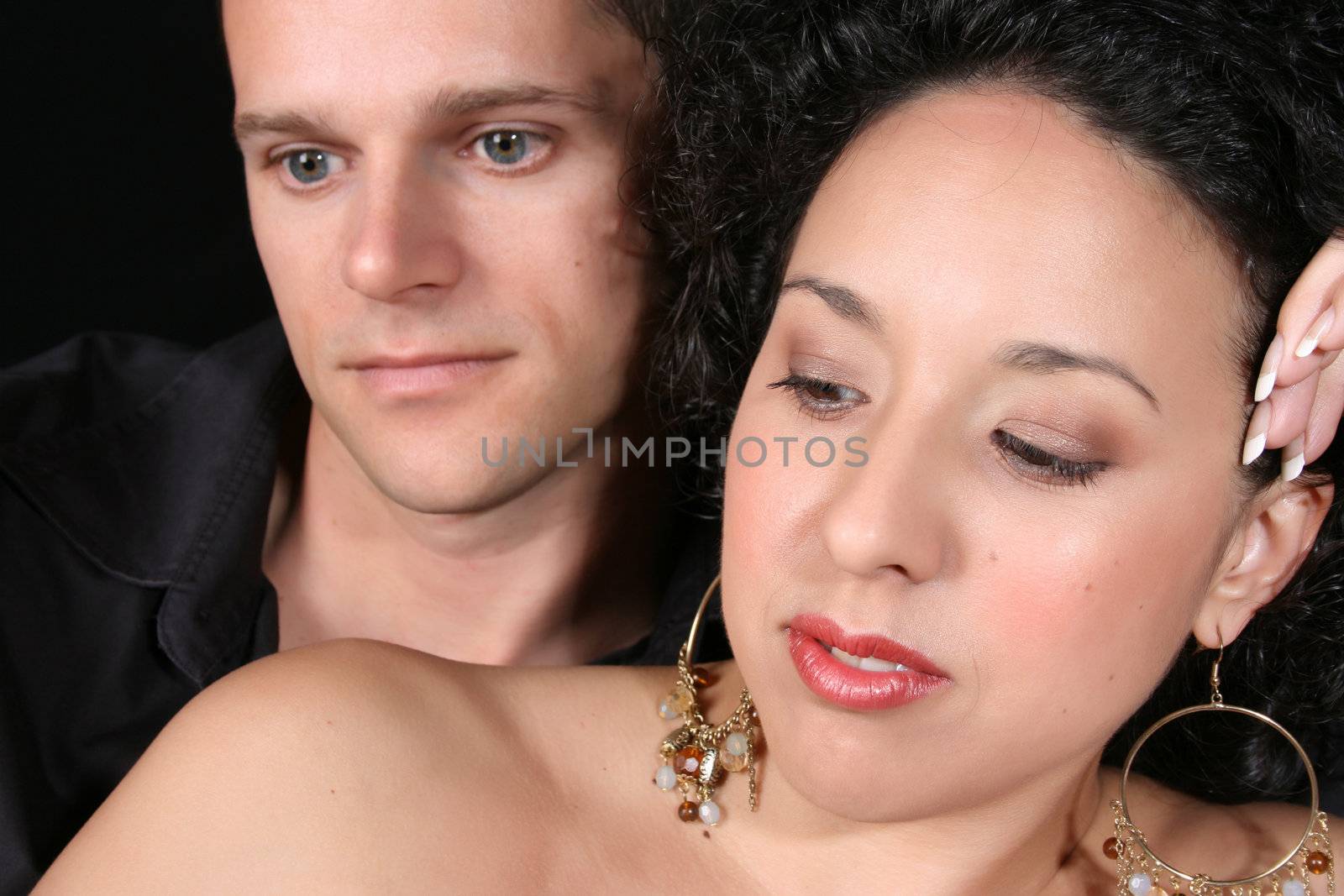 Beautiful young brunette couple with serious expressions