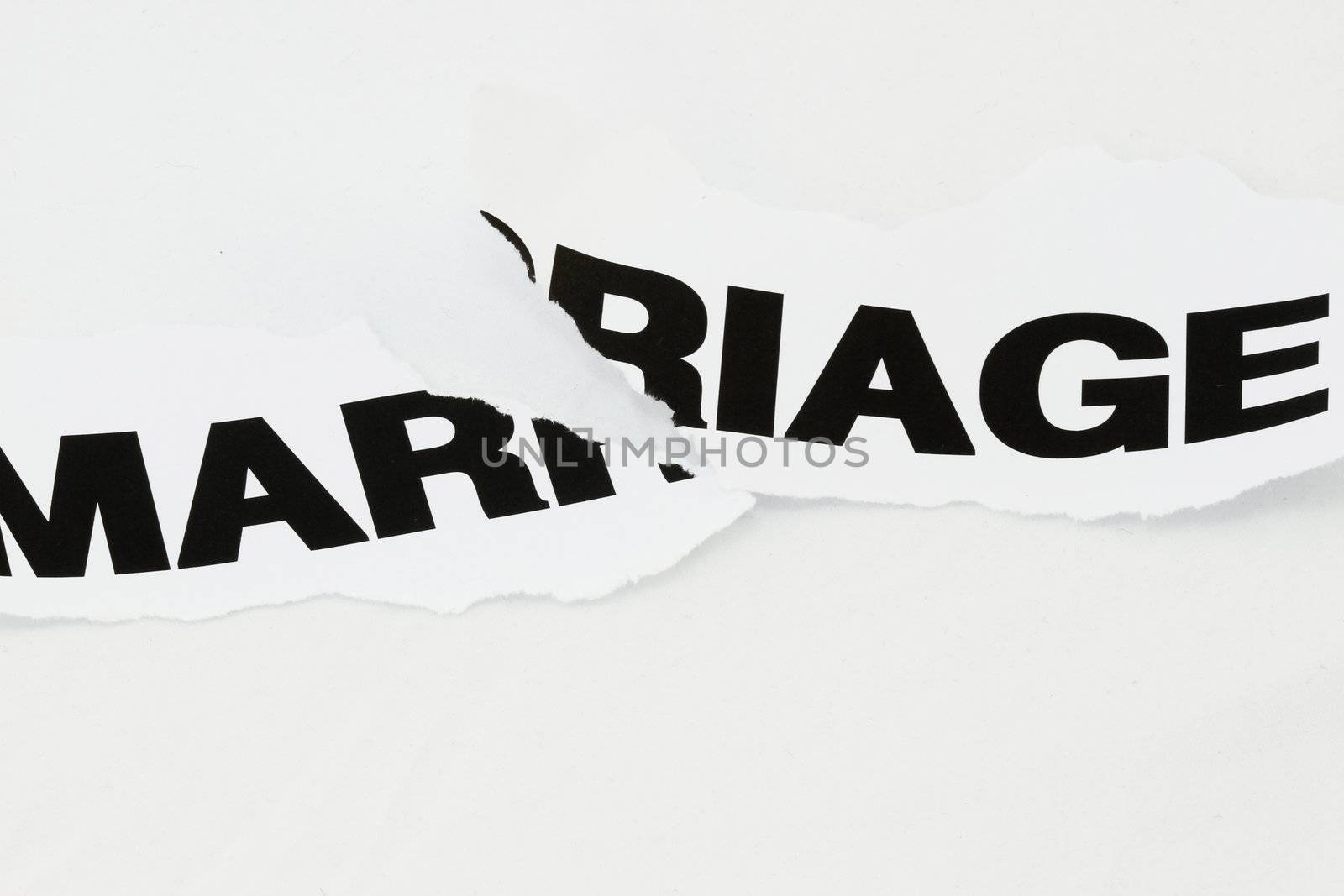 Word Marriage torn apart concept for divorce.