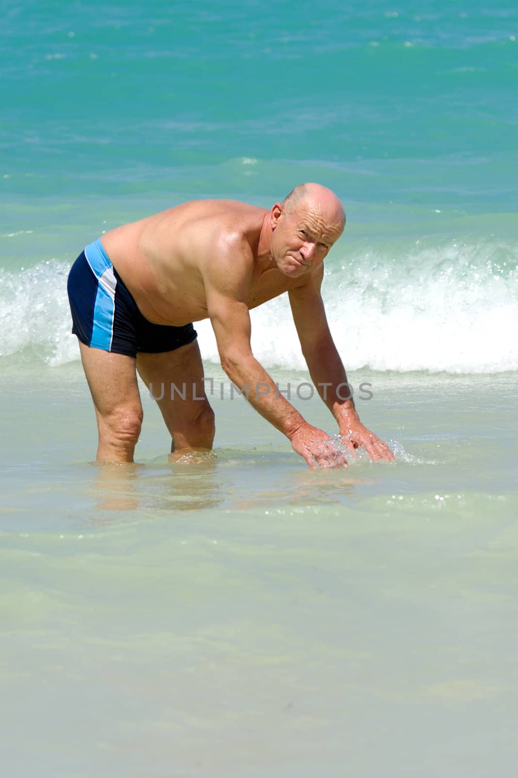 Senior man in water by cfoto