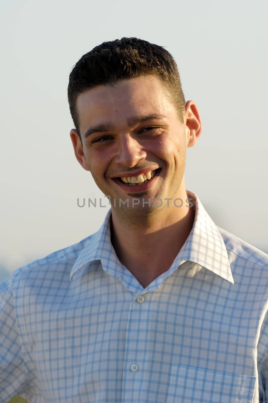 Young man smiling by cfoto