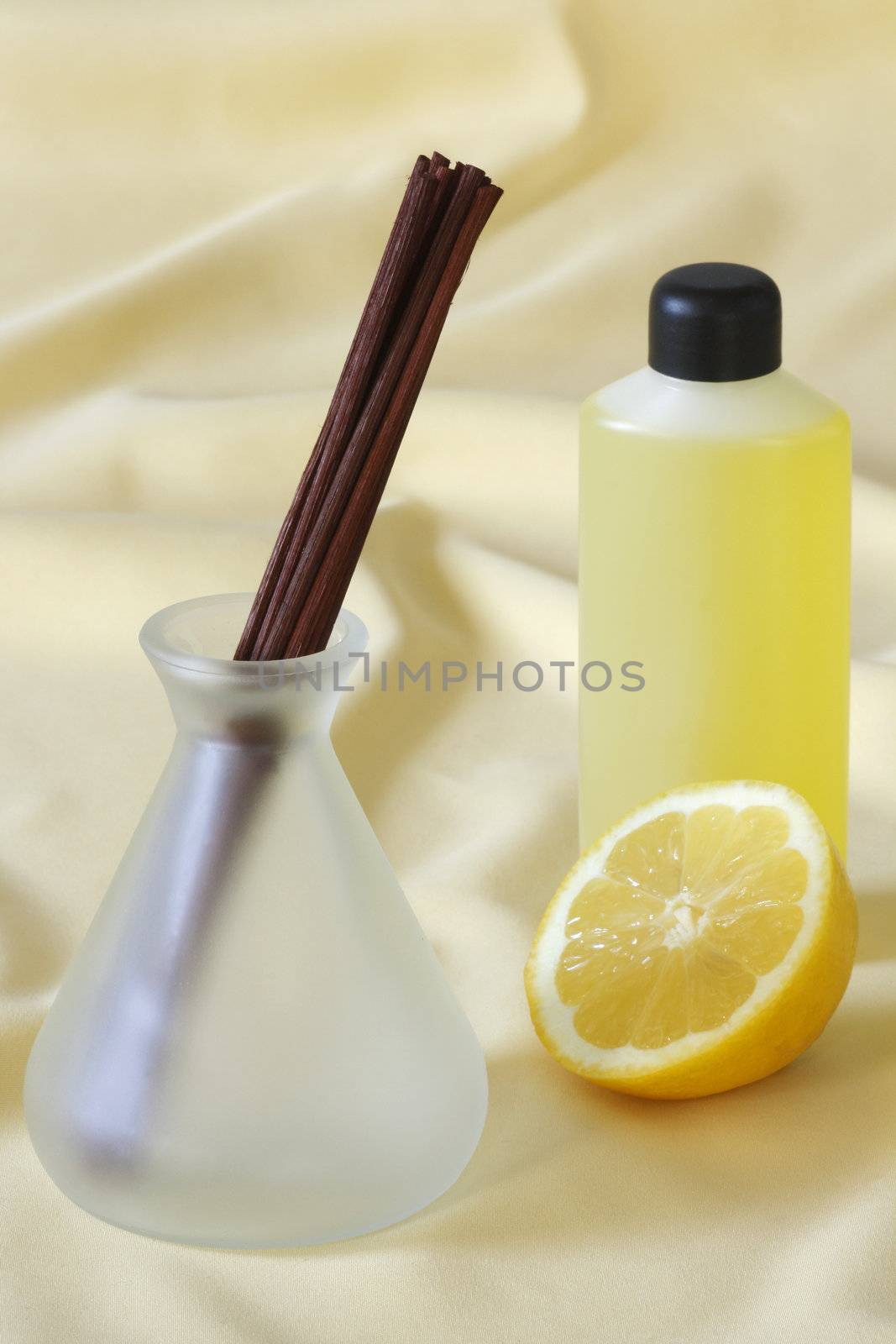 Wooden sticks in essential oil with lemon