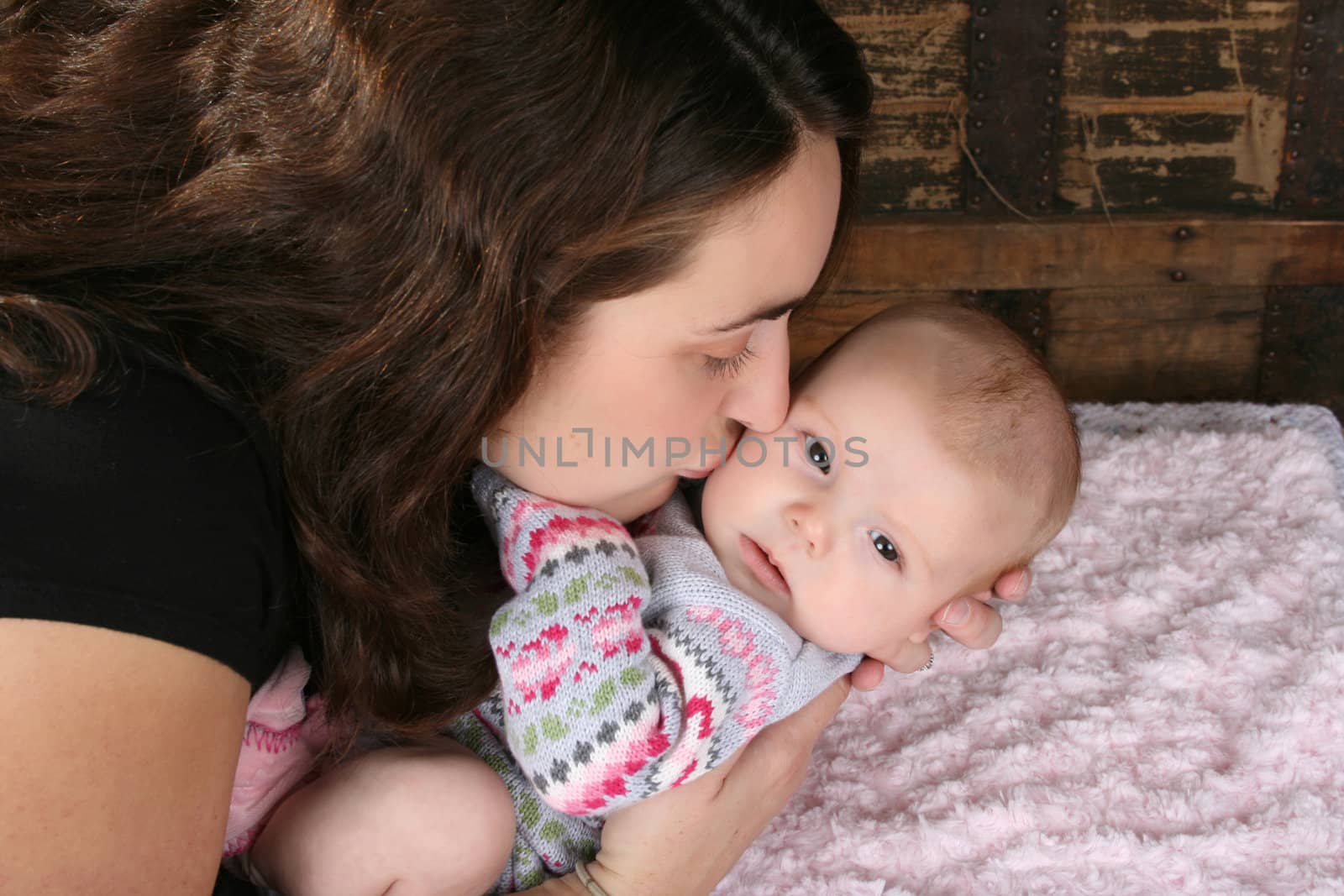 Brunette mother lovingly holding her baby girl