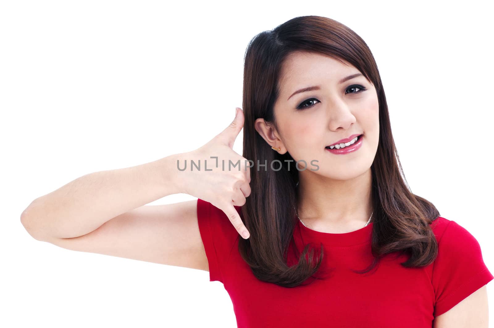 Portrait of an attractive young woman making a call me gesture, isolated on white background.