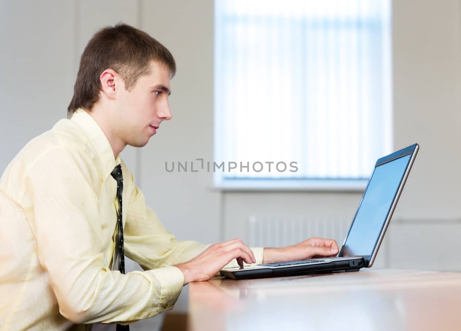 Concentrated businessman working with laptop