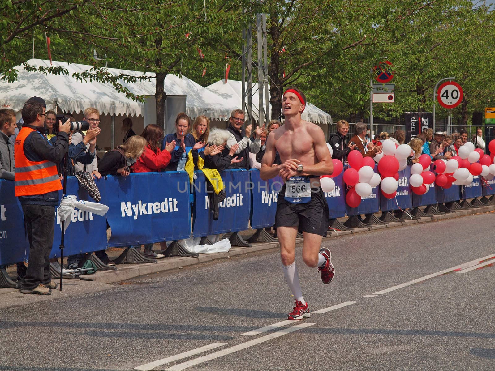 COPENHAGEN - MAY 21: Male runner crossing the finish line at the yearly Copenhagen Marathon. It covers a 42- kilometre route within the city centre in Copenhagen, Denmark.