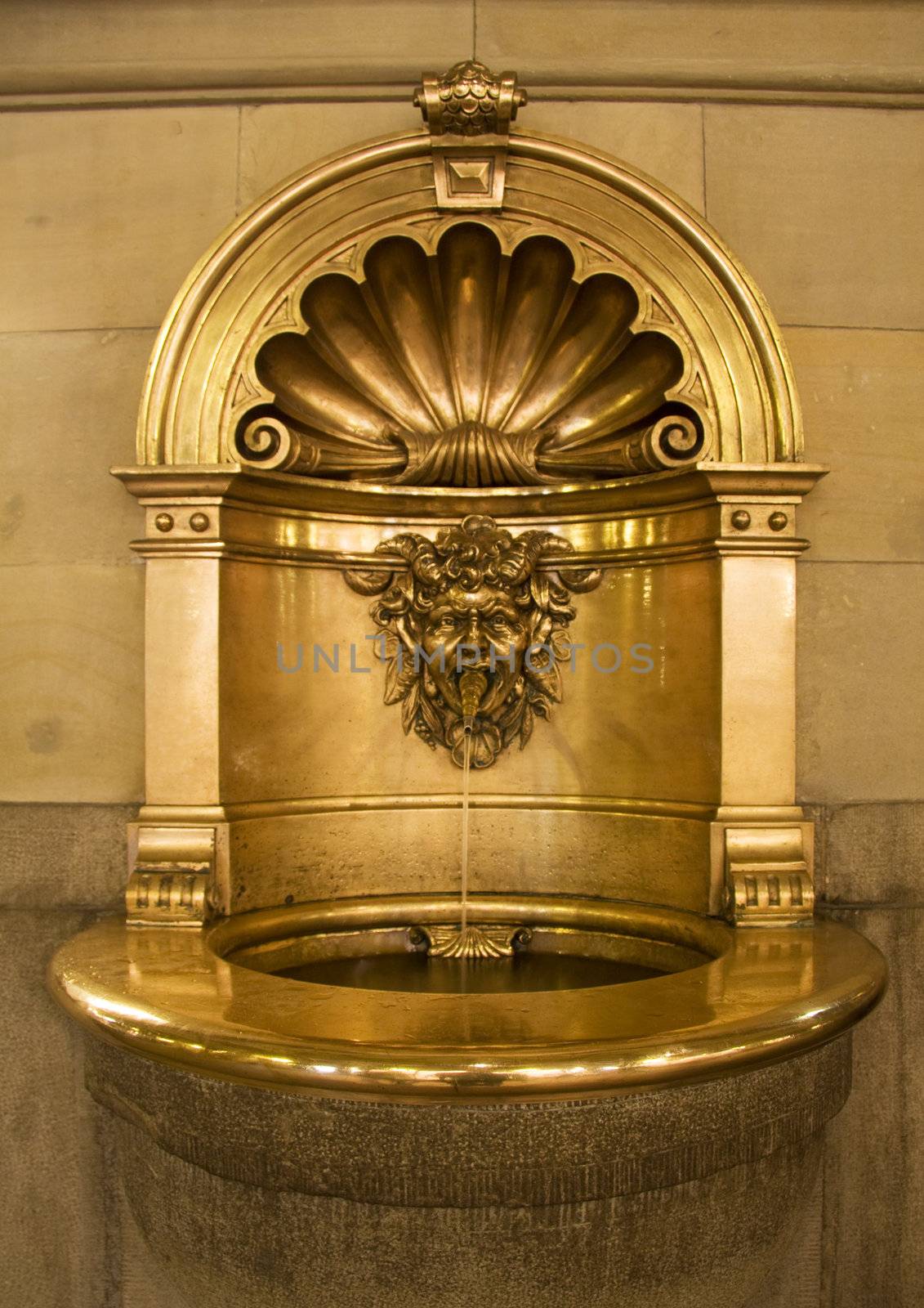 Gold baptismal font that works as a small fountain as well