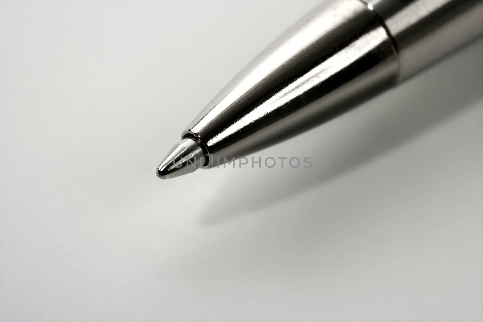 Macro roller silver gray pen point over white background