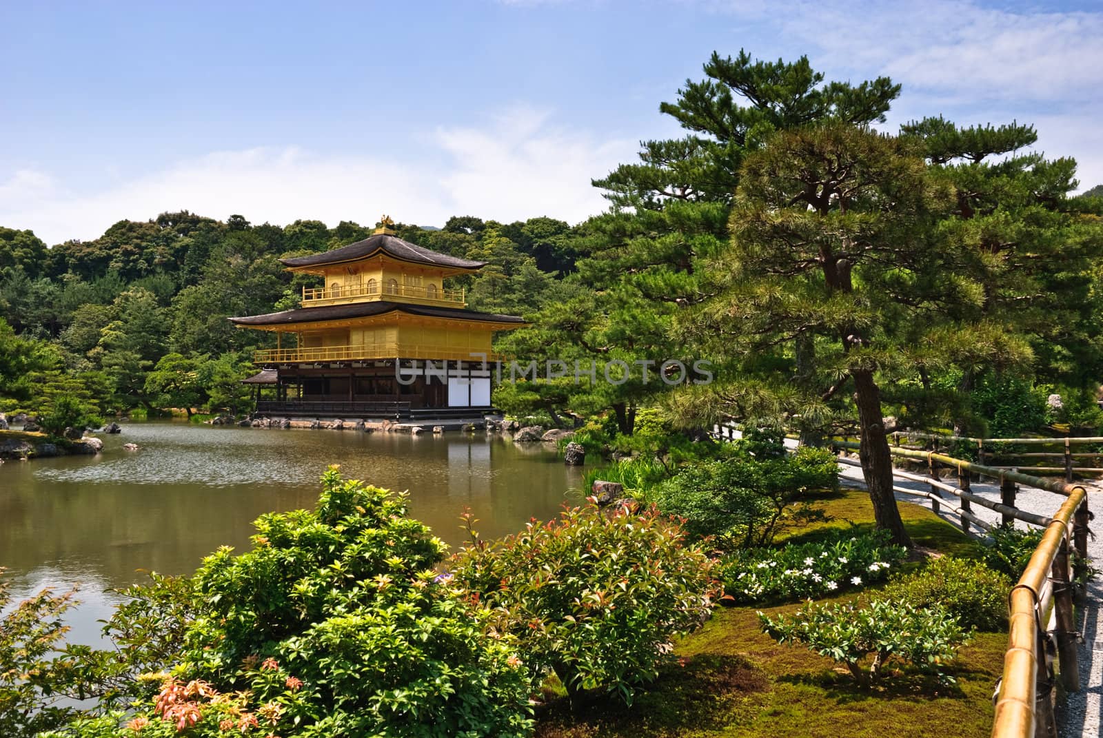 Kinkaku-ji temple, in Kyoto, Japan. The top two stories of the pavilion are covered with pure gold leaf.