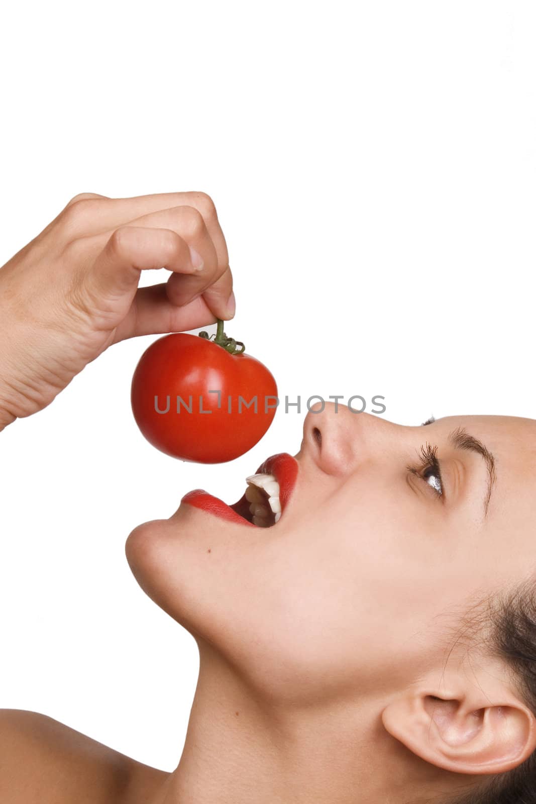 Young Woman Eating Tomatoes. Portrait of smiling attractive young woman with ripe tomato, white background, freshness and healthy food concept