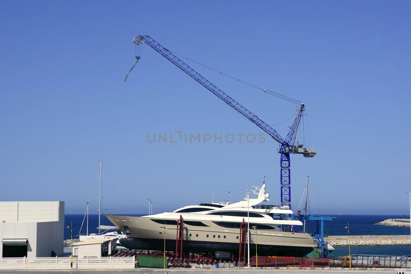 Beached boat with crane on storage area luxury yacht