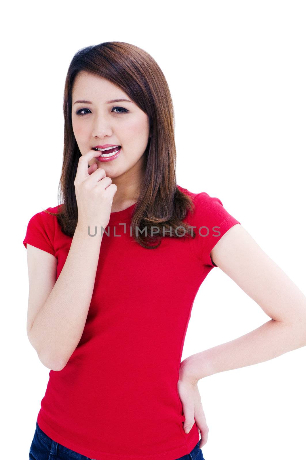 Portrait of an attractive young woman biting her finger, isolated on white.