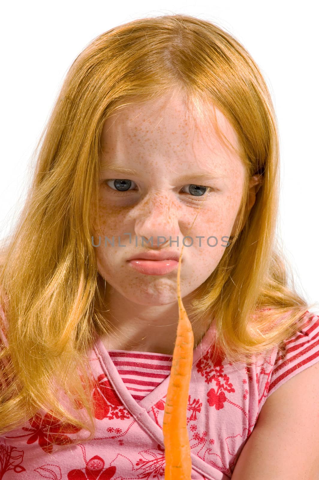 girl is looking disgusting to a carrot isolated on white
