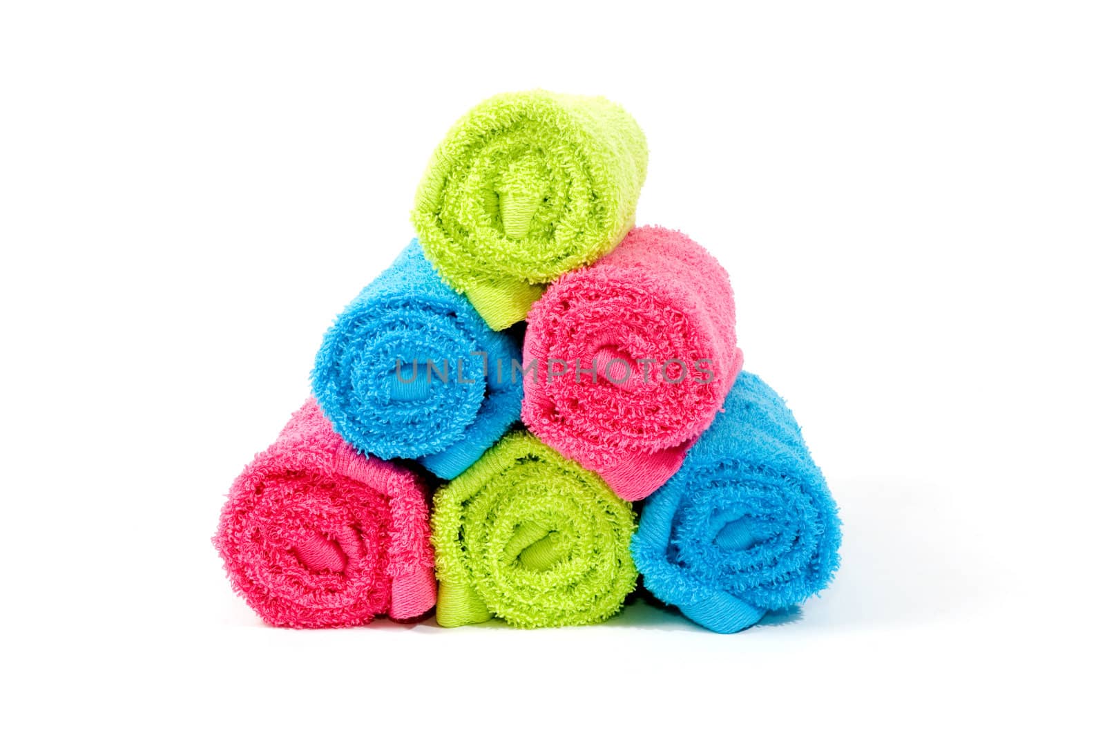 Colorful towel rolls on a white background by ladyminnie