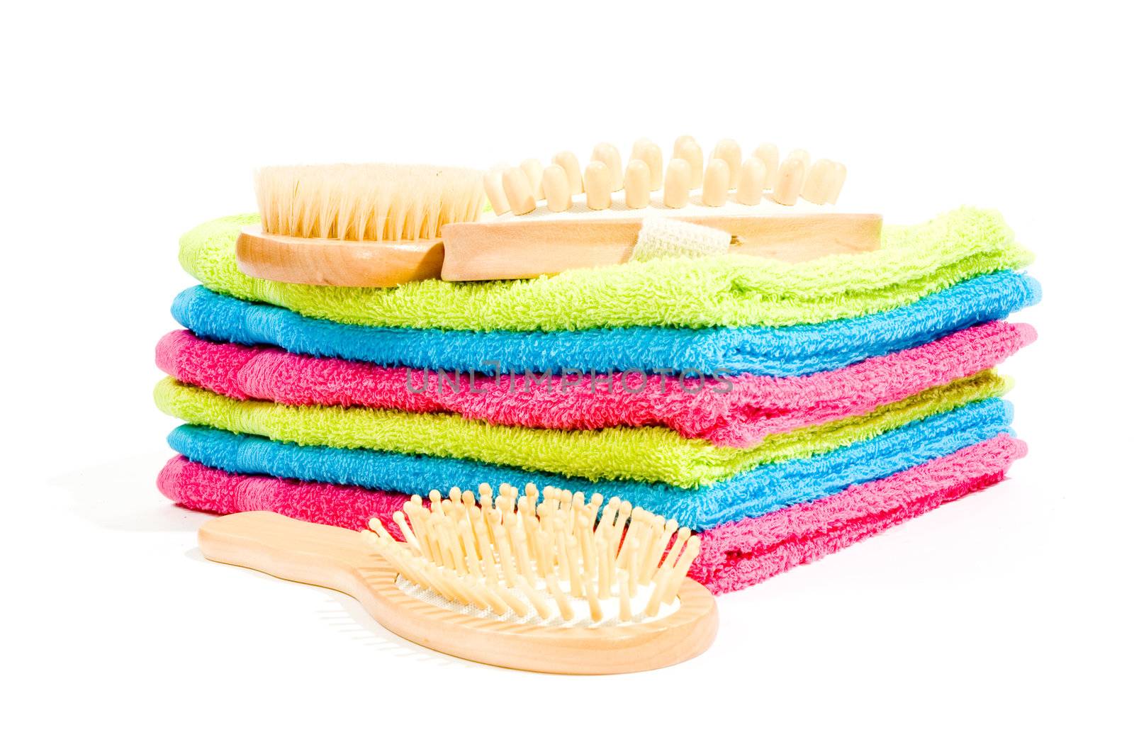 Multicolour towels with spa objects on white background