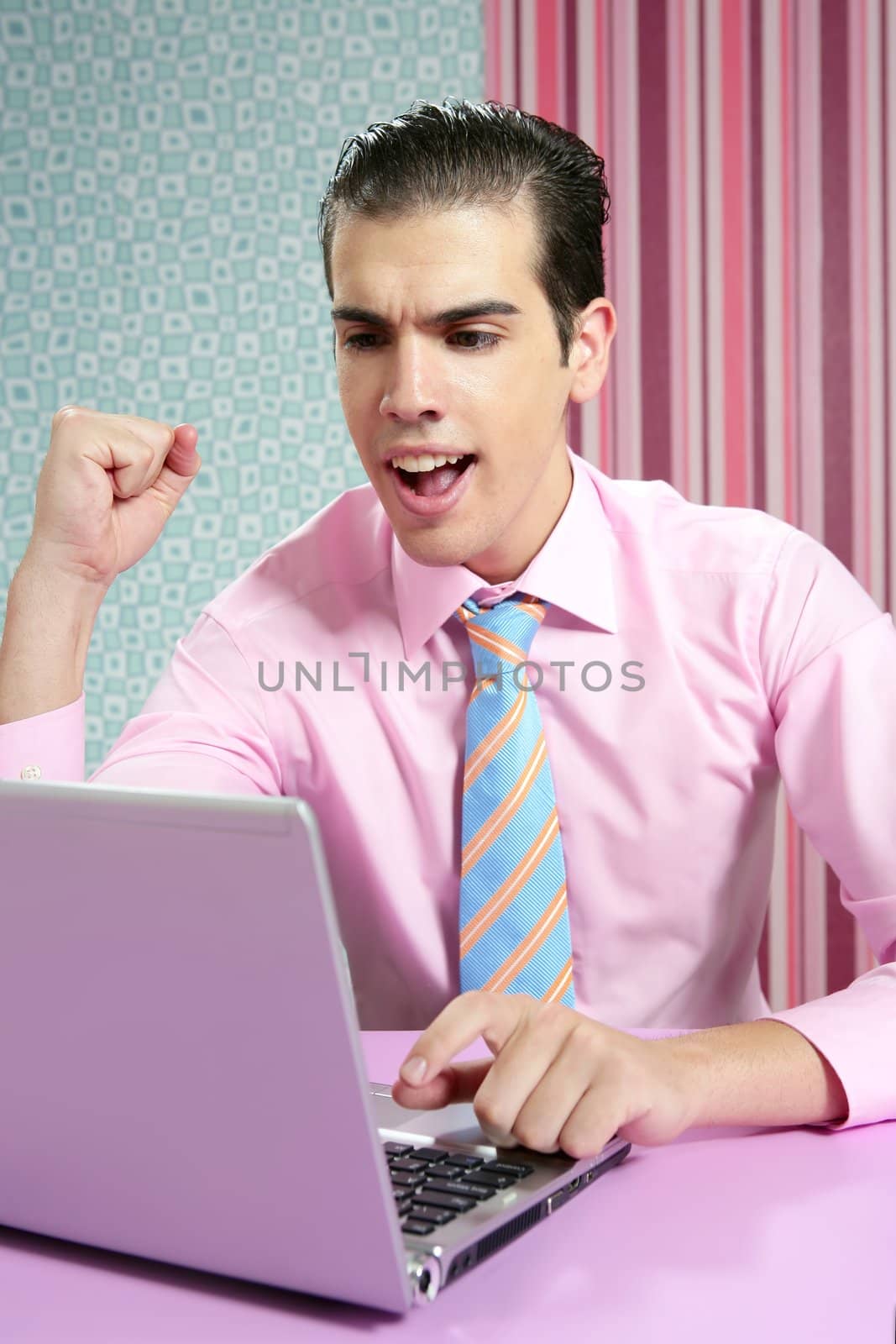 Happy successful young businessman in modern wallpaper office