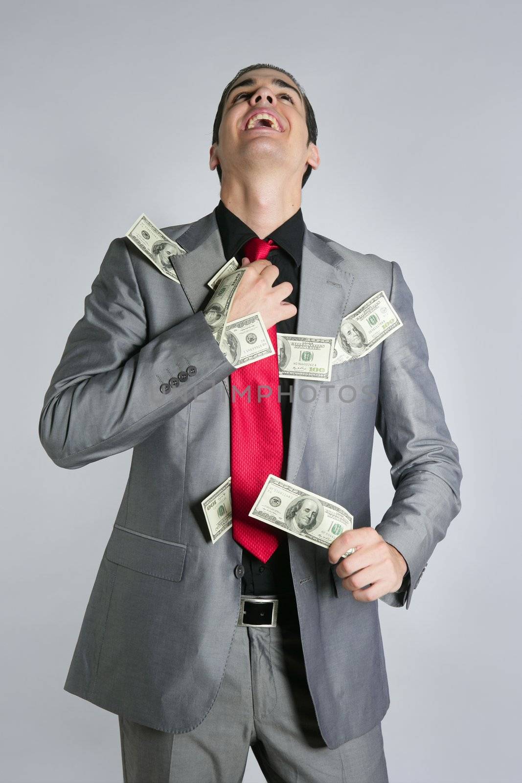 Businessman young with dollar notes suit and tie on gray background