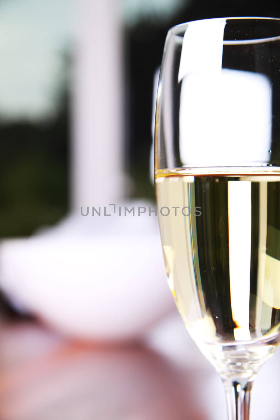 Close-up of a champagne glass on a mahoney table