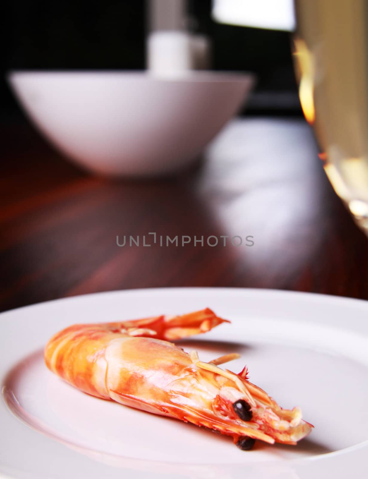 Giant shrimp on a plate and a glass of champagne