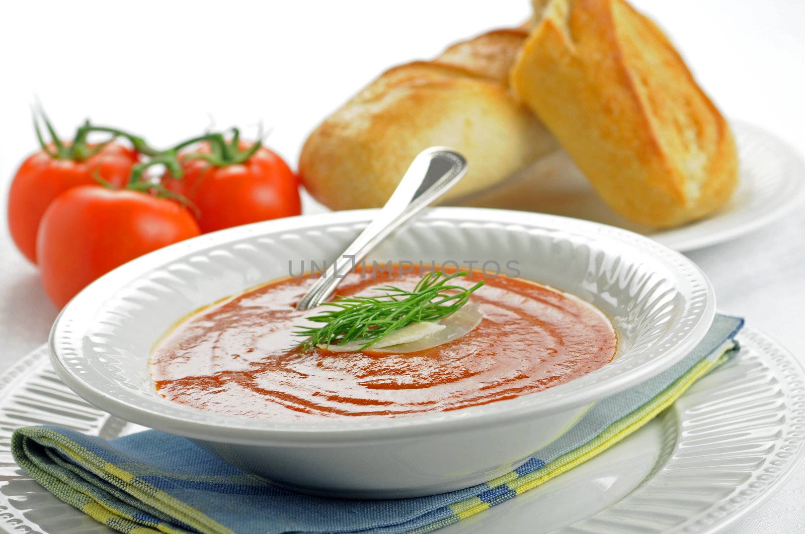 Bowl of homemade tomato soup garnished with dill.