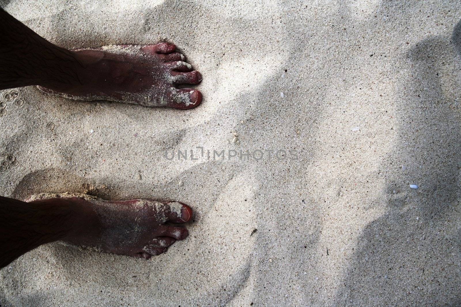 Feet on the beach in Aruba, Dutch Caribbean.