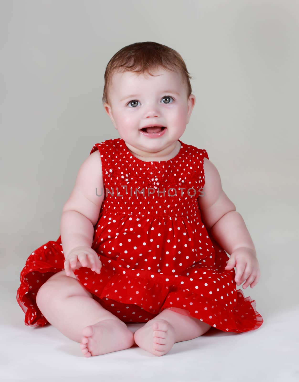 cute caucasian baby girl wearing red dress