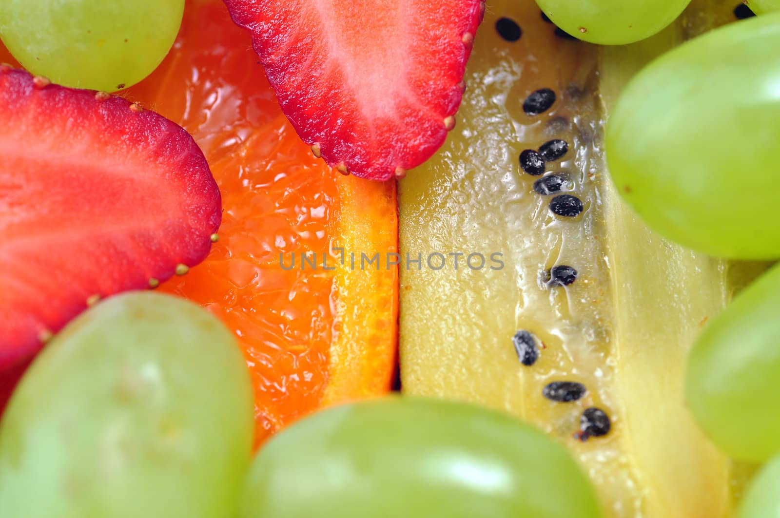 Delicious healthy colorful fruit salad: perfect food or diet background.