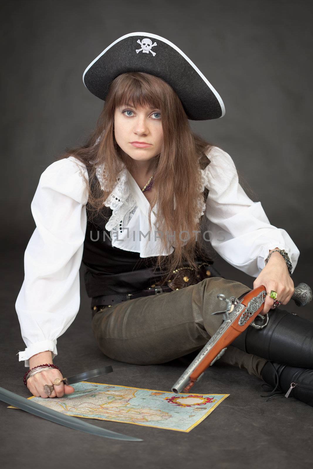Woman - pirate with sea map and pistol on a black background