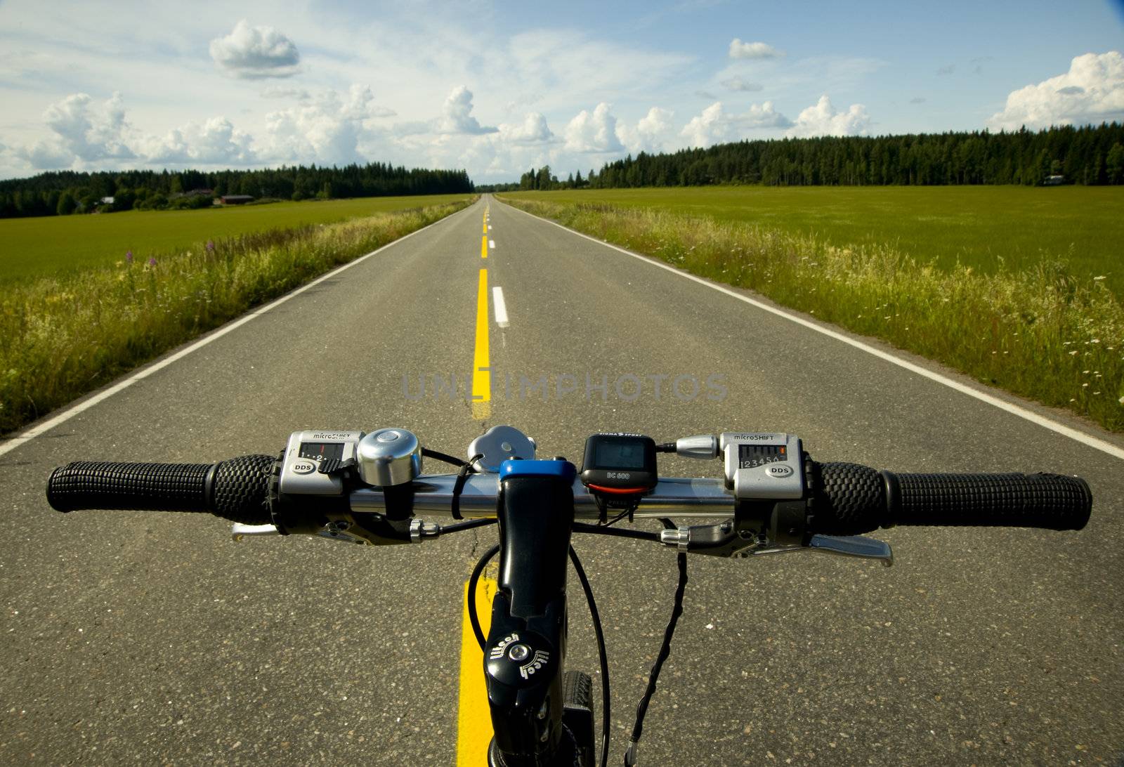 Bicycle on the road and field taken in Finland on July 2009