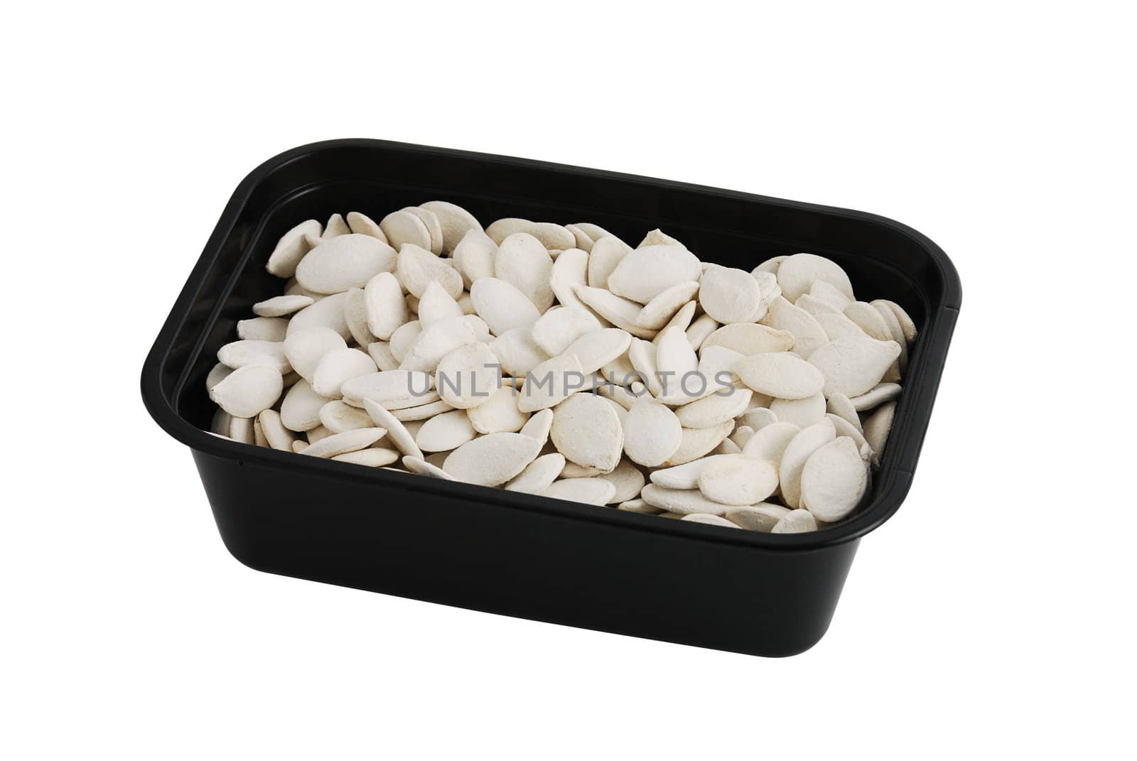 Dried salted pumpkin white seeds  in black plastic bowl isolated on white background