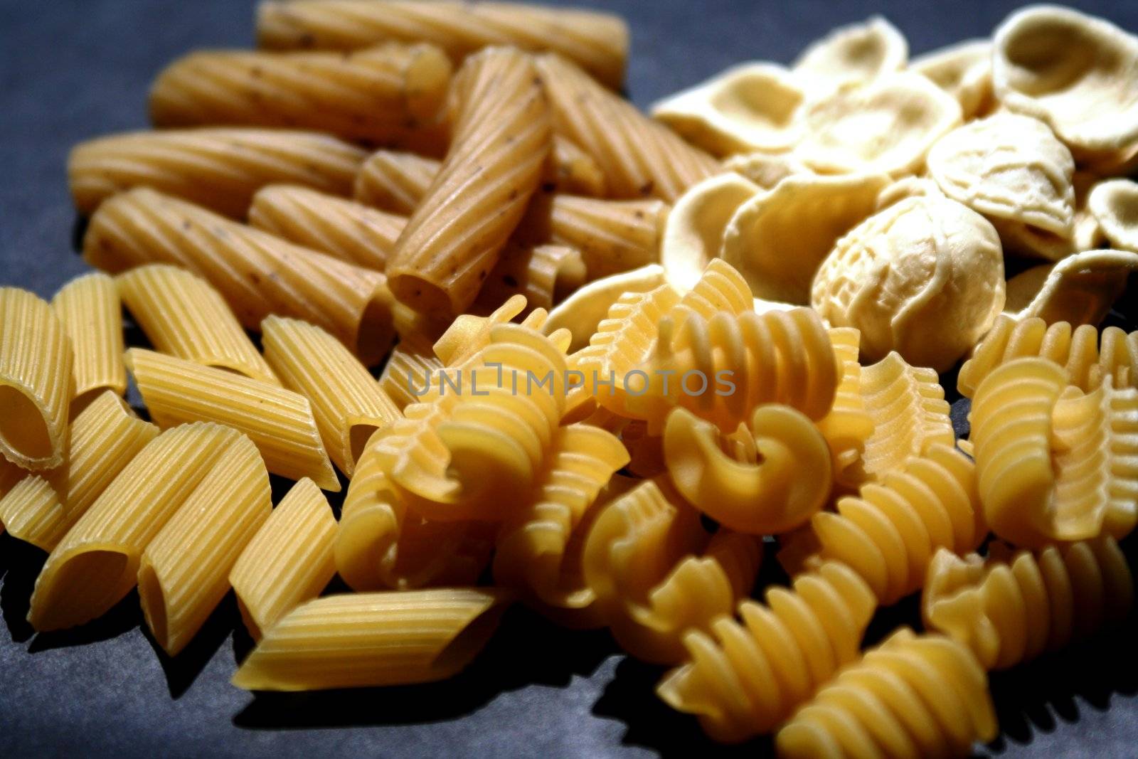 Italian pasta on black background