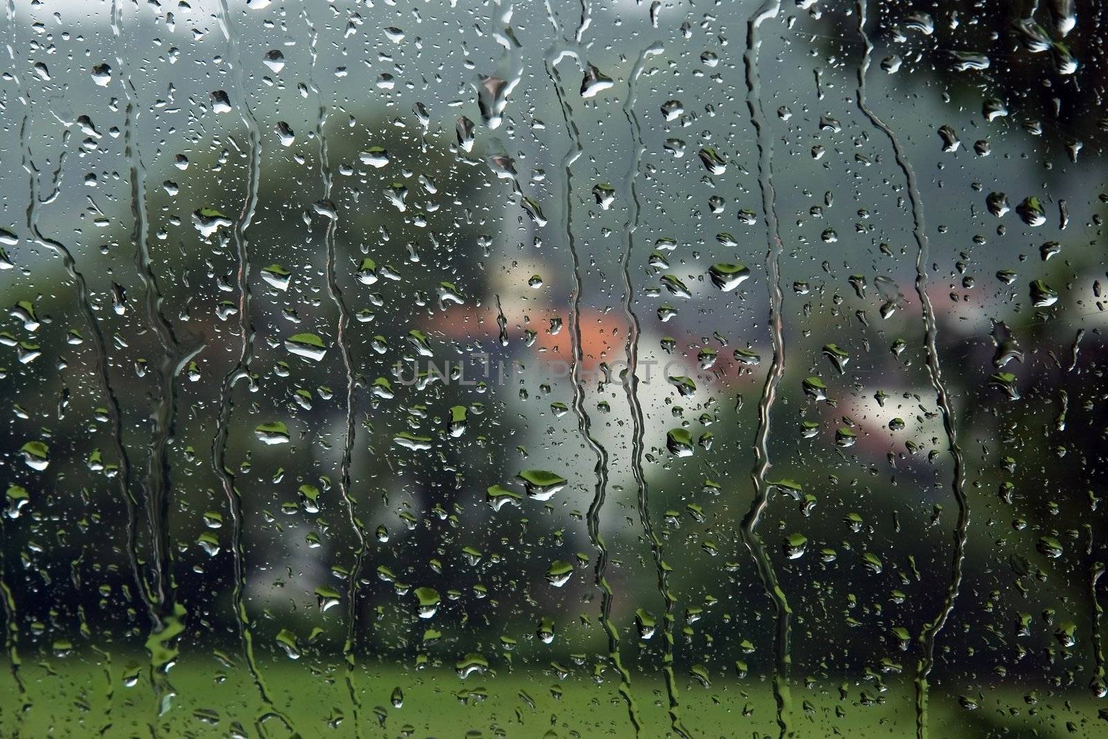 View on small village through carglass in the rain 