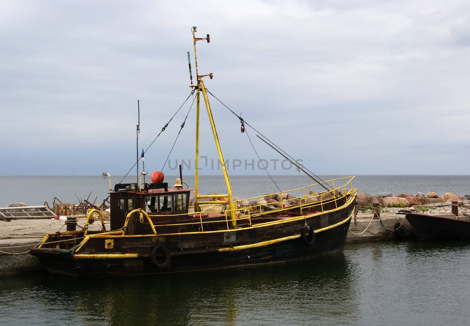 The wooden boat is at the pier