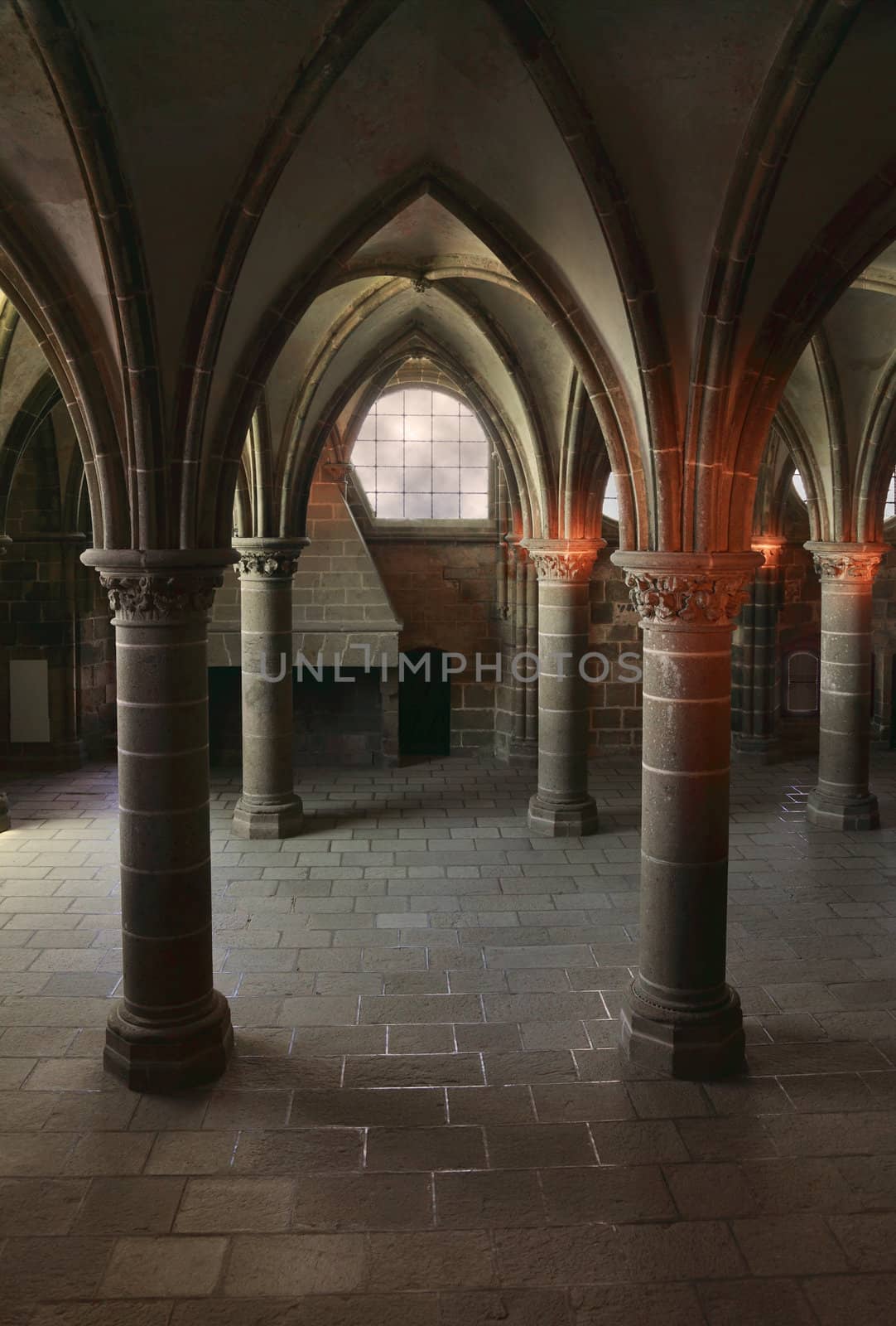 Gothic columns and arches inside the monastry from Mount St Michel,France.