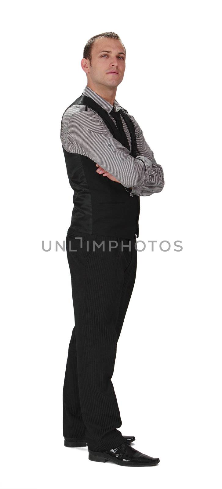 Young confident businessman standing up against a white background.