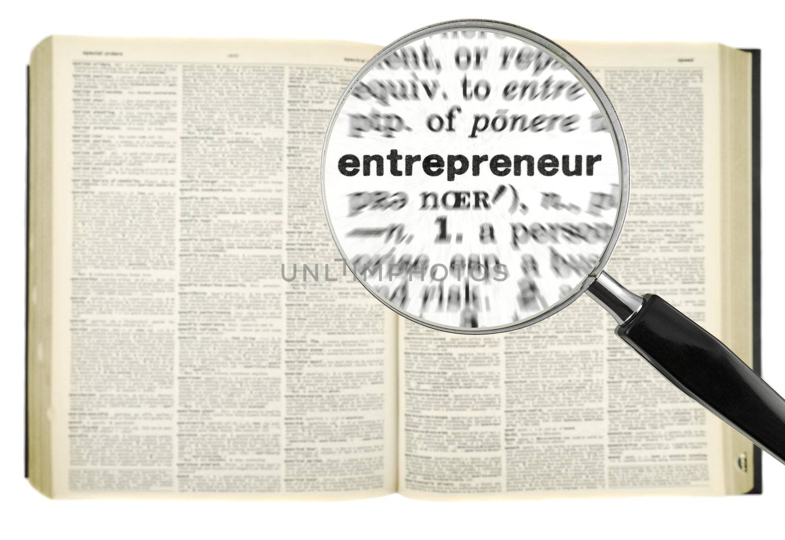 A magnifying glass on the word ENTREPRENEUR on a dictionary. Isolated on white.