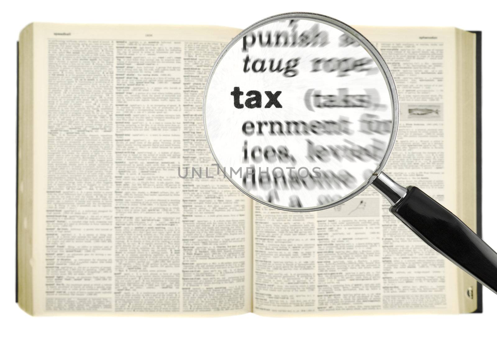 A magnifying glass on the word TAX on a dictionary. Isolated on white.