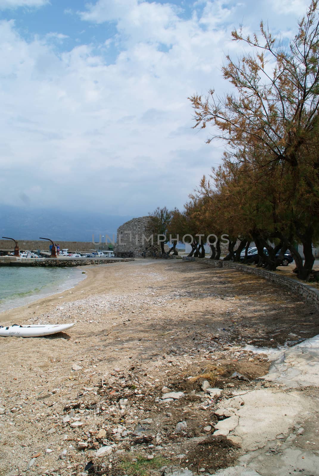 Beach photographed with a blue, cloudy sky in the background. The boat on the beach.