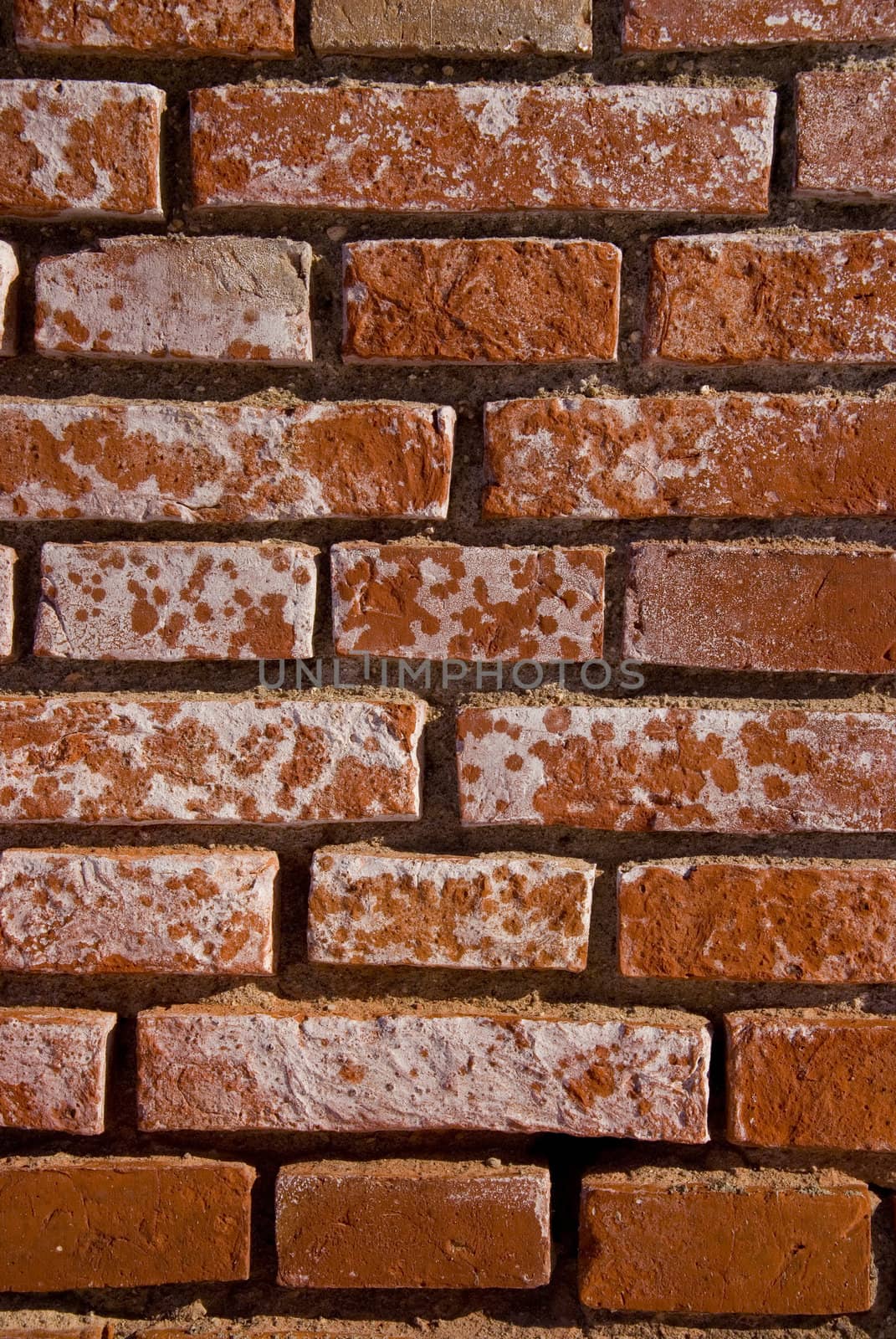 Old red brick wall fragment. Architectural background.