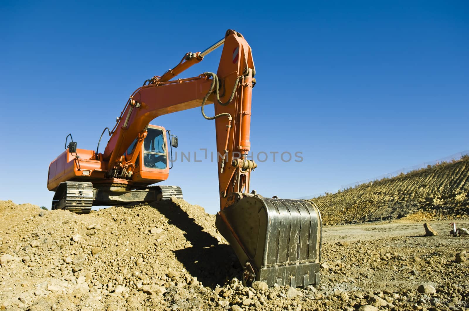 Excavator in a road construction