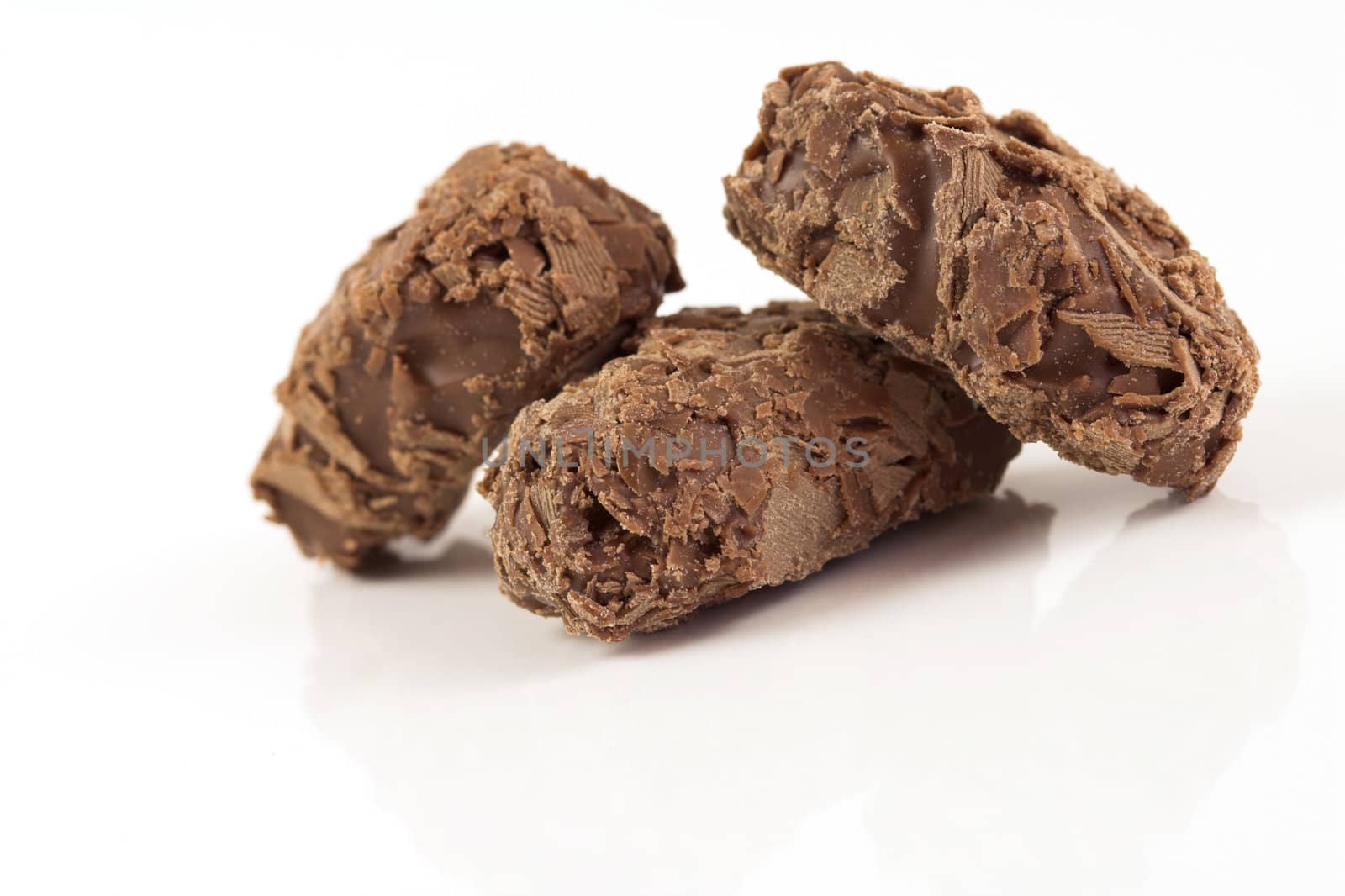Delicious chocolate truffles on white background