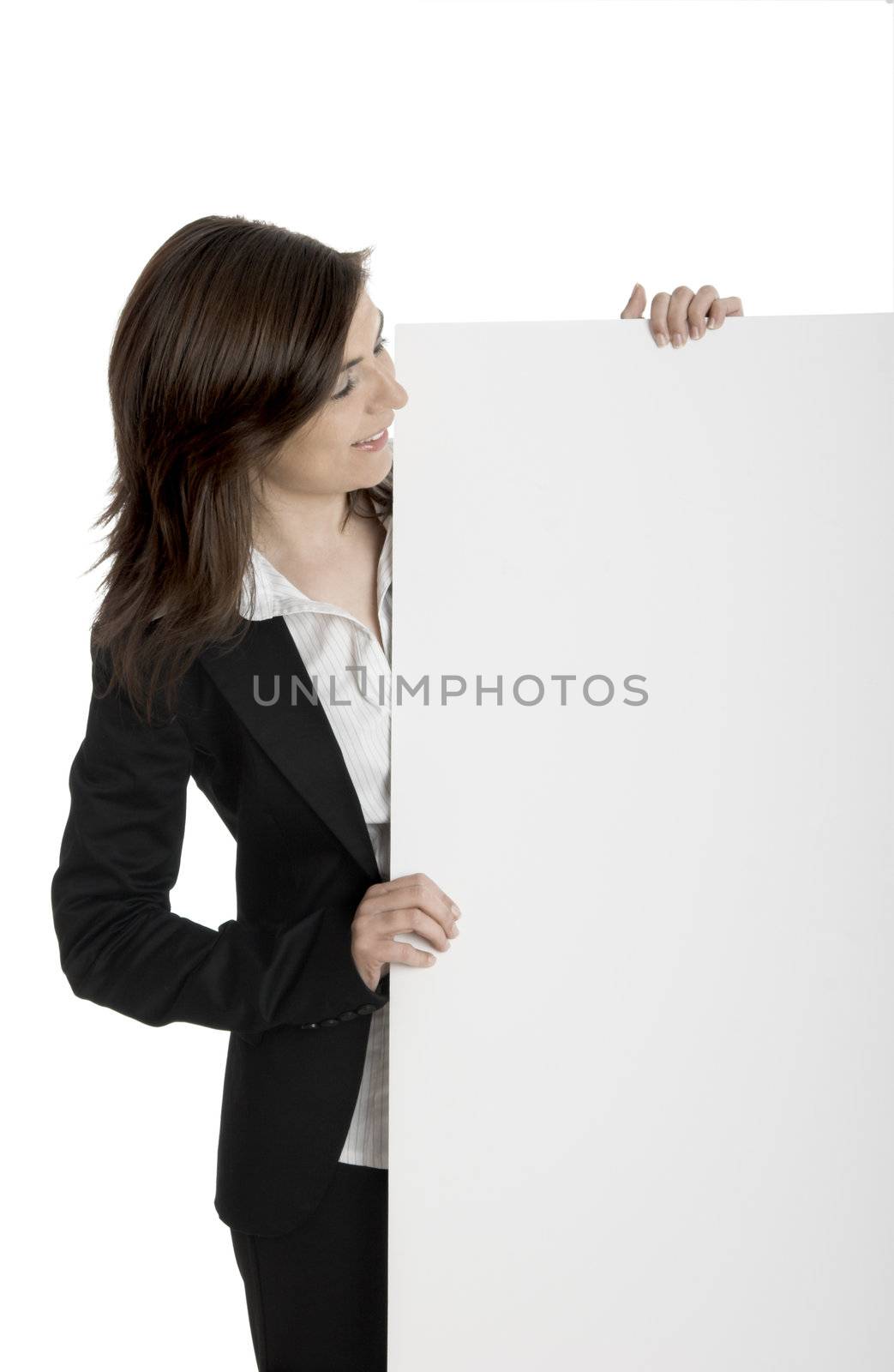 Portrait of a happy beautiful woman holding and looking to a billboard