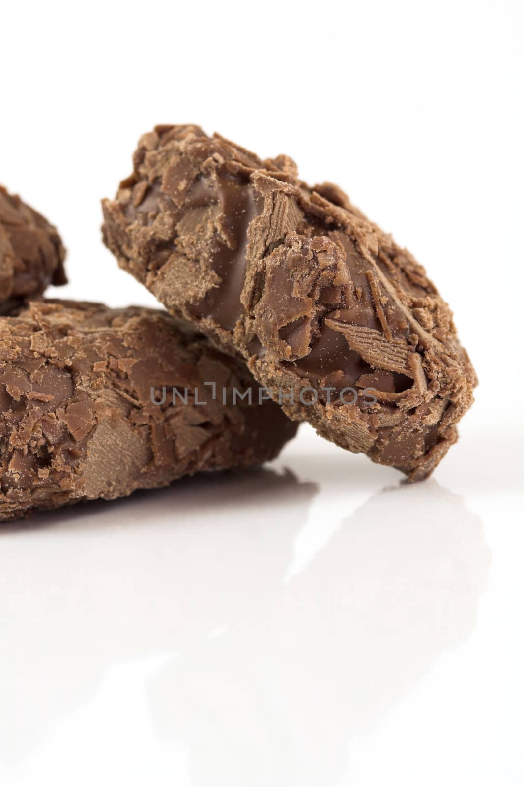 Delicious looking chocolate truffles on white background